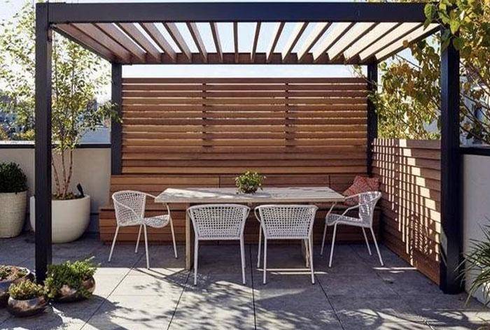 Pergola for seating area with chairs and tables in garden